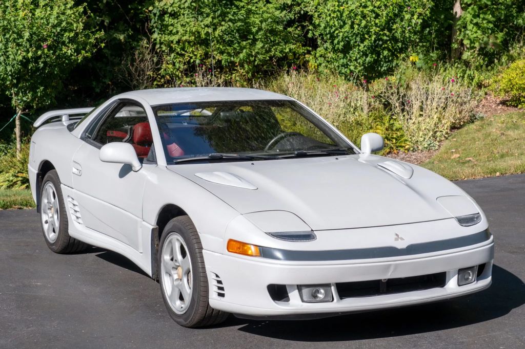 A white 1991 Mitsubishi 3000GT VR-4 5-Speed parked outside in right front angle view