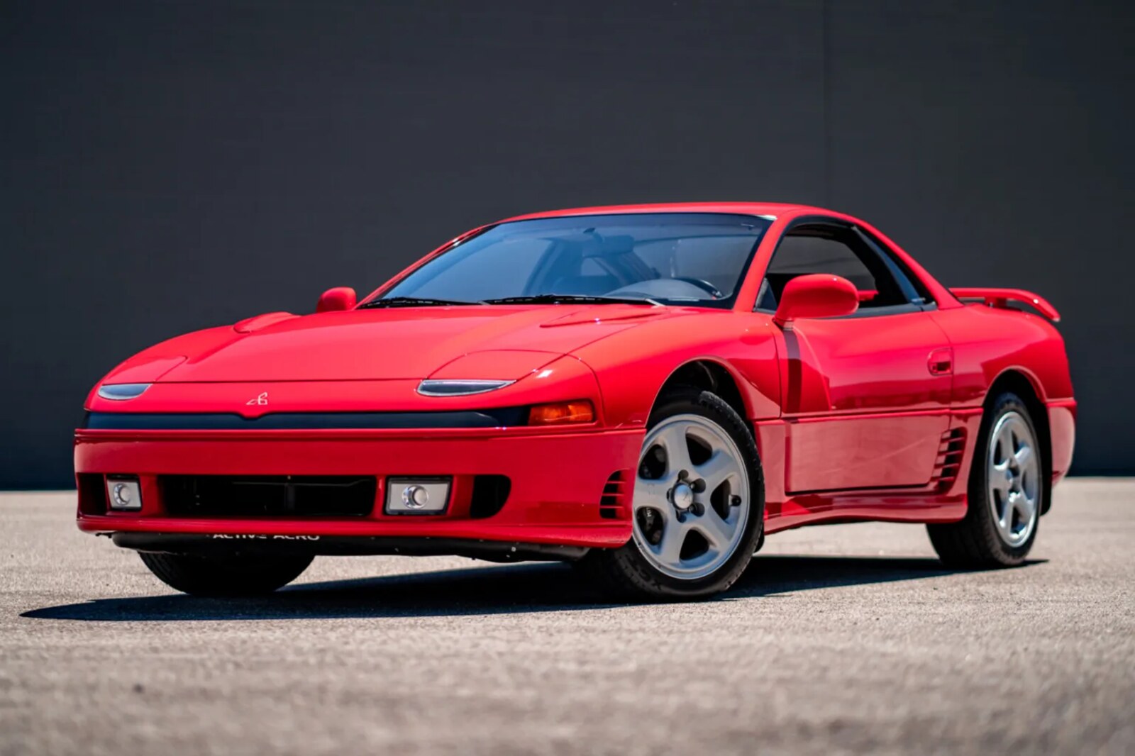 A red 1991 Mitsubishi 3000GT VR-4 parked in left front angle view