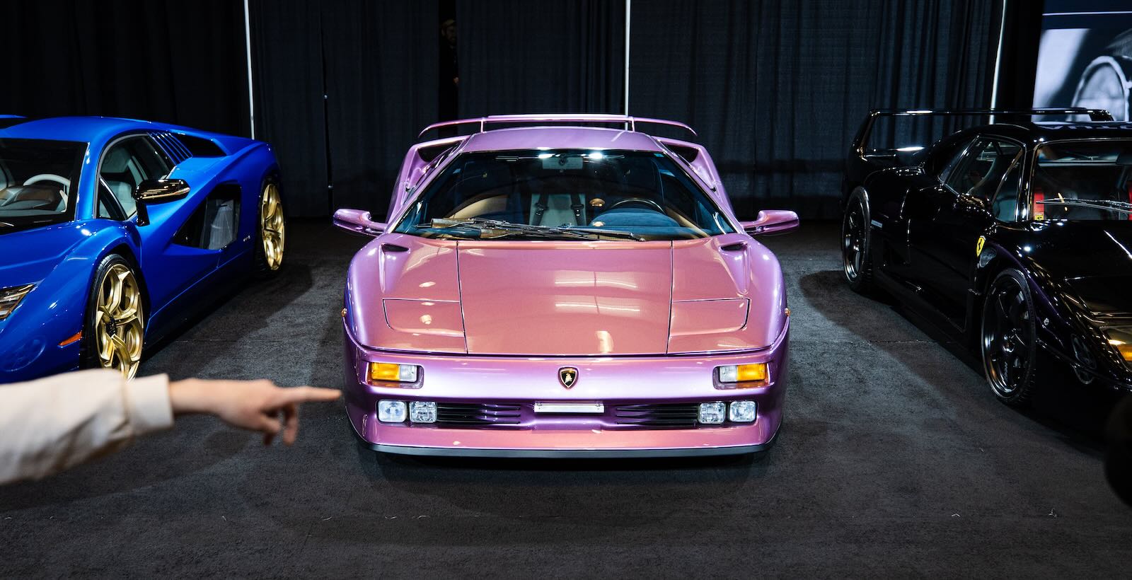 Purple Lamborghini Diablo SE30 special edition on stage at a car show.