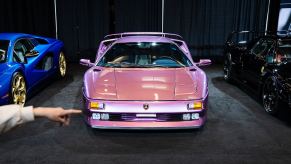 Purple Lamborghini Diablo SE30 special edition on stage at a car show.