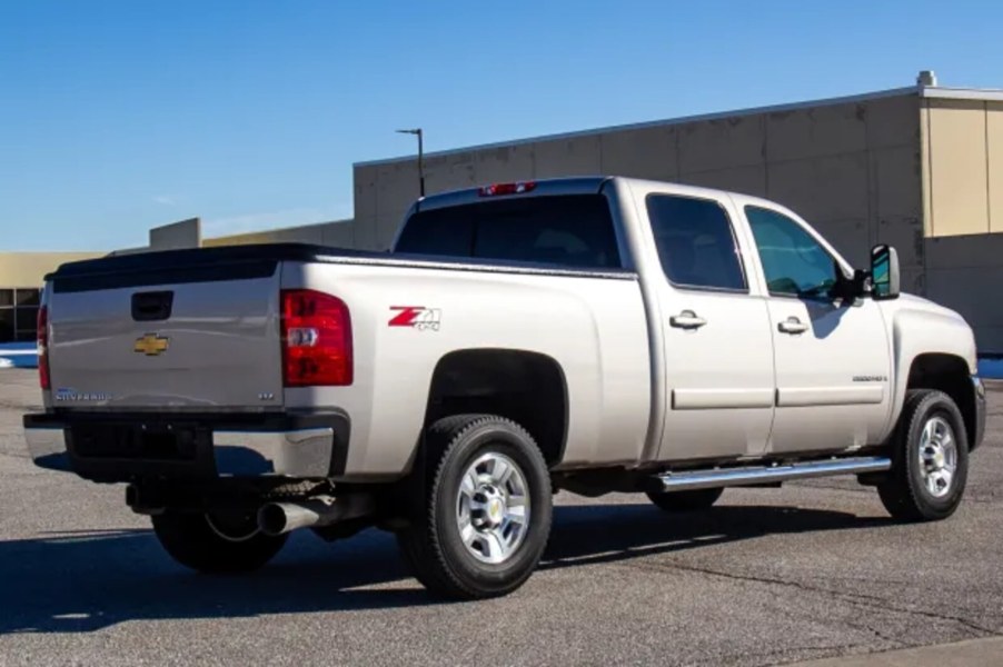 A light metallic 2008 Chevrolet Silverado 2500HD parked in right rear corner view