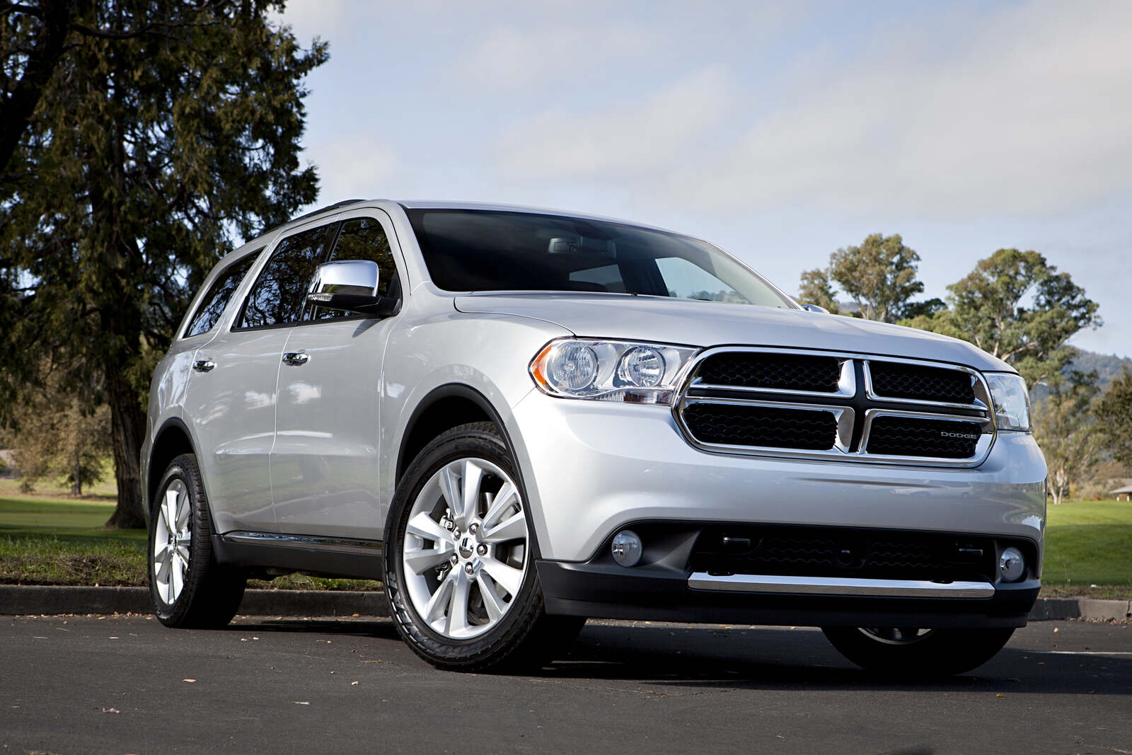 A silver 2013 Dodge Durango parked in low right front angle view