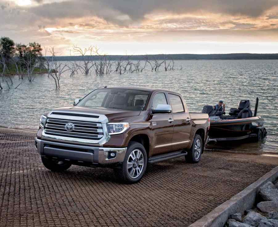 A 2018 Toyota Tundra with a trailer backed into water unloading a fishing boat
