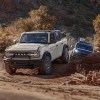 Two 2025 Ford Bronco SUVs off-roading