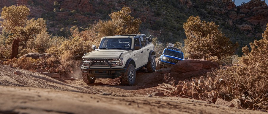 Two 2025 Ford Bronco SUVs off-roading