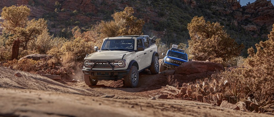 Two 2025 Ford Bronco SUVs off-roading
