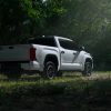 A white 2025 Toyota Tundra TRD parked in shadowy right rear angle view