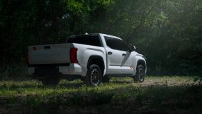A white 2025 Toyota Tundra TRD parked in shadowy right rear angle view