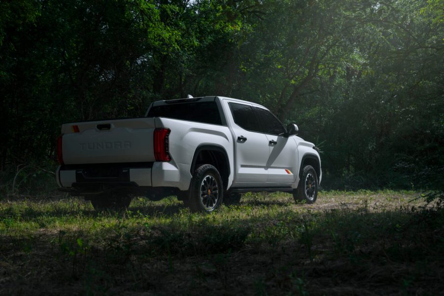 A white 2025 Toyota Tundra TRD parked in shadowy right rear angle view