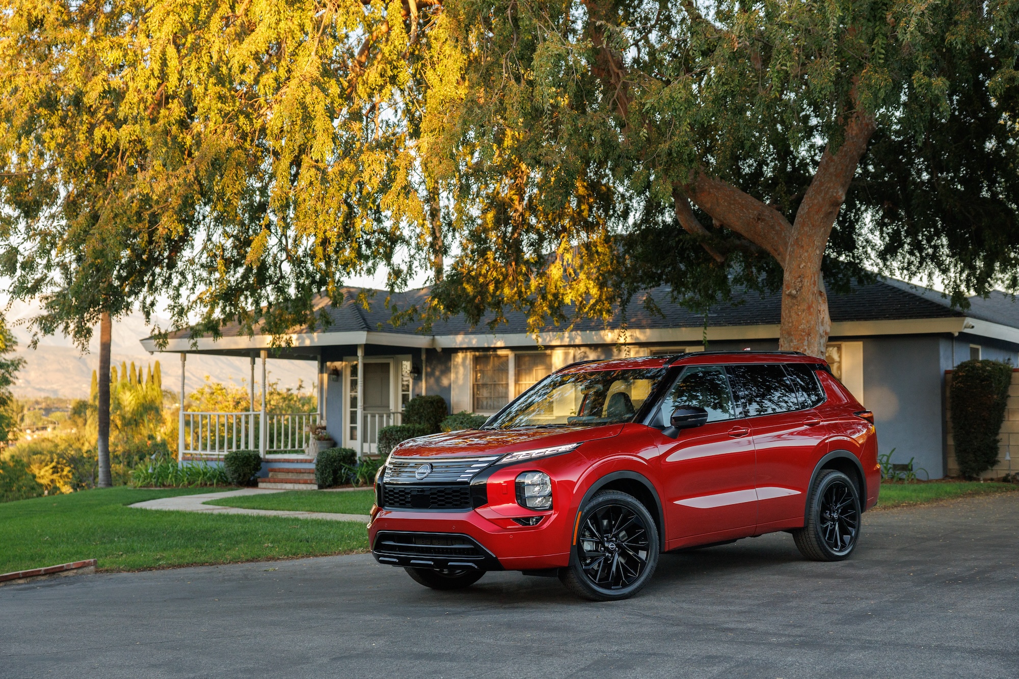 The 2026 Nissan Rogue PHEV near a home