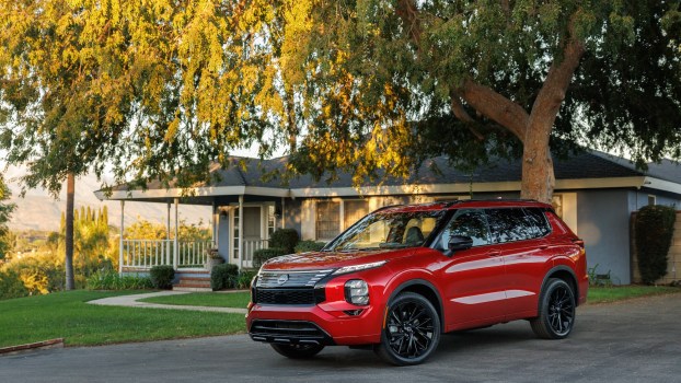 The 2026 Nissan Rogue PHEV near a home
