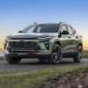 A matte-greenish 2026 Chevrolet Trax parked in left front angle view at dusk