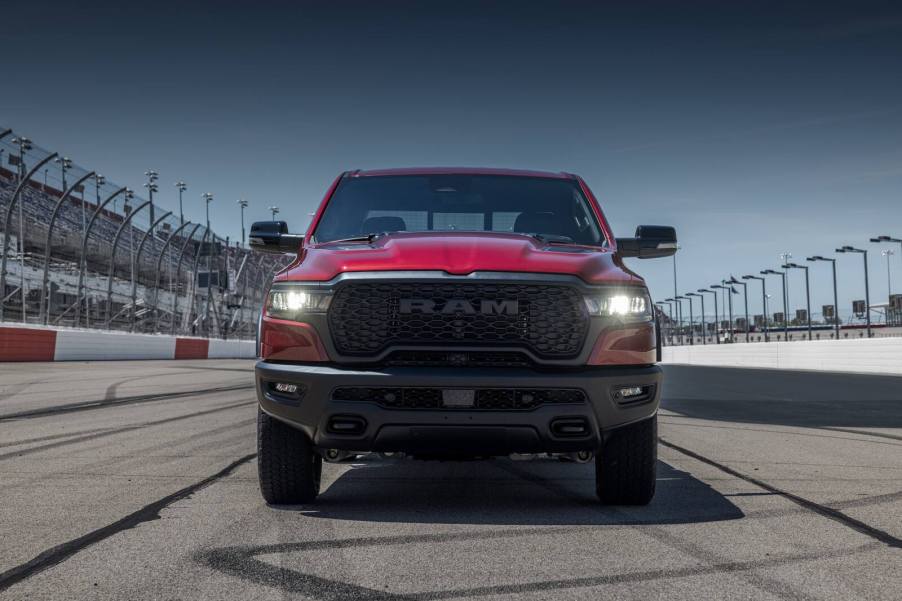 A red 2026 Ram 1500 Rebel parked on a track in direct front view