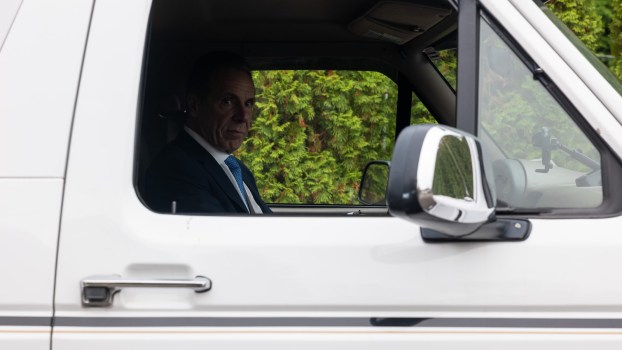 Retired New York Governor Andrew Cuomo sits in the driver's seat of his white Ford Bronco.