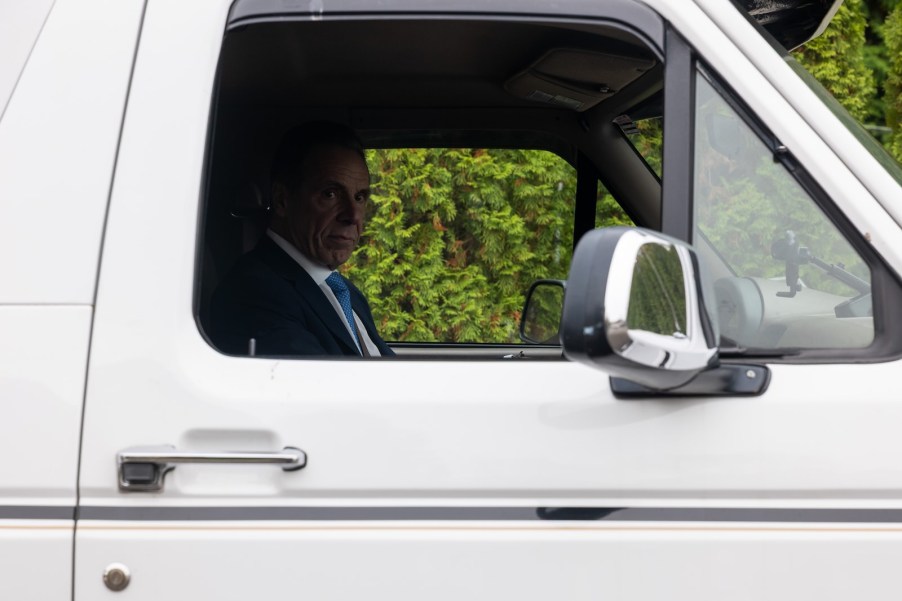 Retired New York Governor Andrew Cuomo sits in the driver's seat of his white Ford Bronco.