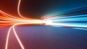 Red and blue lights speeding down a highway on the Autobahn