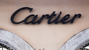 The Cartier logo on the side of a tan building in Rome