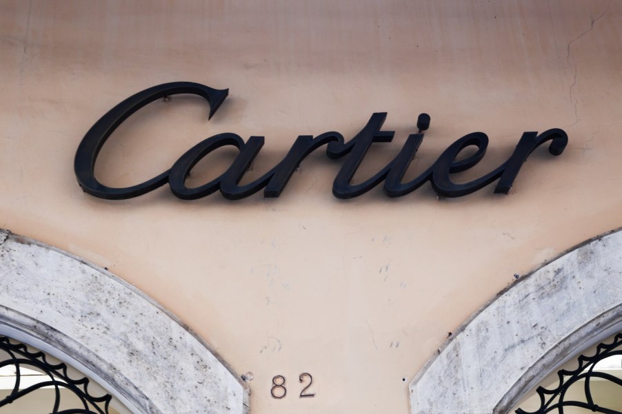 The Cartier logo on the side of a tan building in Rome
