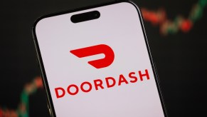 The red Doordash logo on a white screen on a phone.