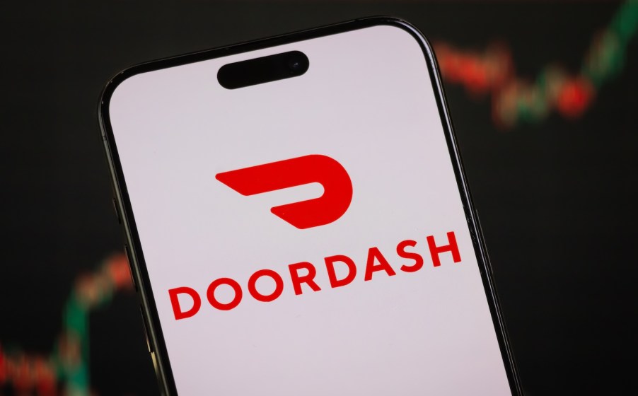 The red Doordash logo on a white screen on a phone.