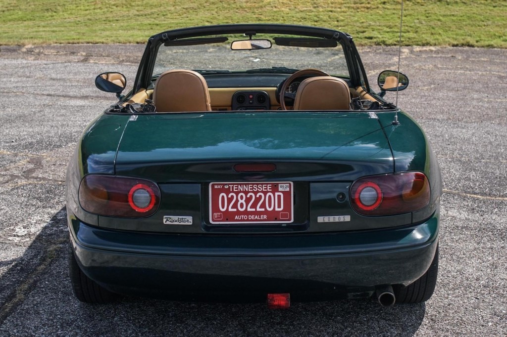The trunk and rear of a dark green convertible