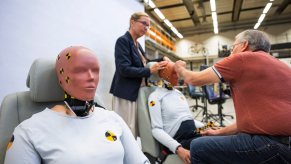 The world's first female crash test dummy in the foreground, Swedish researchers in the background.