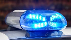 The flashing blue lights on the roof of a police cruiser car.