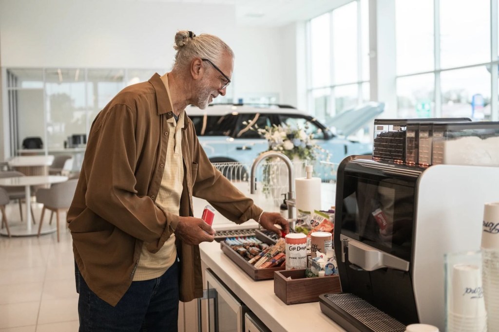 Ford customer browsing snacks, a Bronco Sport visible in the background.