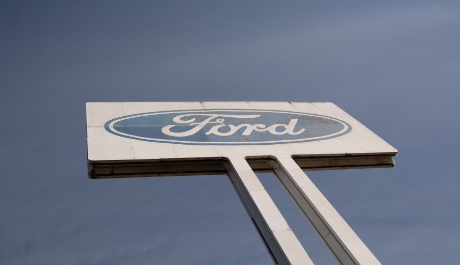 A Ford sign overhead, a blue sky in the background.