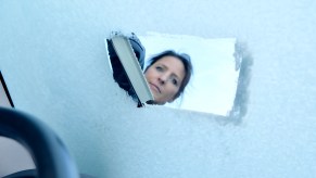 A woman defrosting a windshield