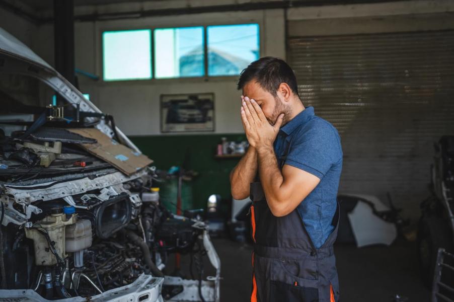 A frustrated mechanic doesn't love working on this truck.