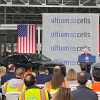 Tennessee workers at the GM Ultium battery plant listen to a woman speaking from a podium.