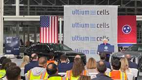 Tennessee workers at the GM Ultium battery plant listen to a woman speaking from a podium.