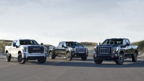 Three GMC Sierra 3500HD trucks parked facing the viewer