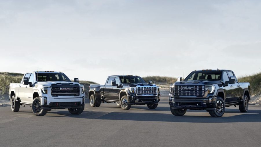 Three GMC Sierra 3500HD trucks parked facing the viewer
