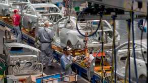 Kansas City factory workers assemble General Motors cars on an assembly line
