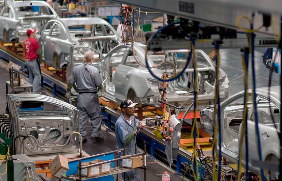 Kansas City factory workers assemble General Motors cars on an assembly line