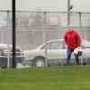 General Motors' factory worker carrying his lunch box across a plant's lawn.