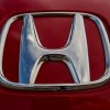 Chrome Honda logo on a red sports car