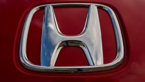 Chrome Honda logo on a red sports car