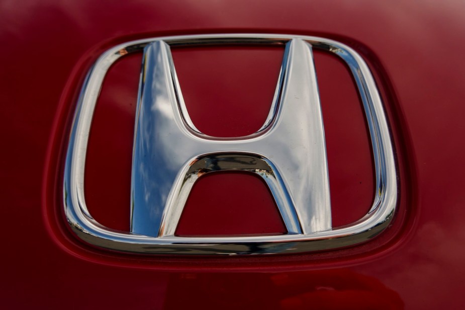 Chrome Honda logo on a red sports car