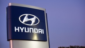 The Hyundai sign above a dealership for Kia cars, doing recall work