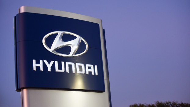The Hyundai sign above a dealership for Kia cars, doing recall work