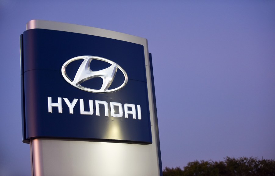 The Hyundai sign above a dealership for Kia cars, doing recall work