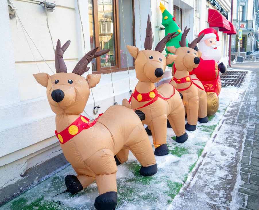 Row of inflatable reindeer on a porch