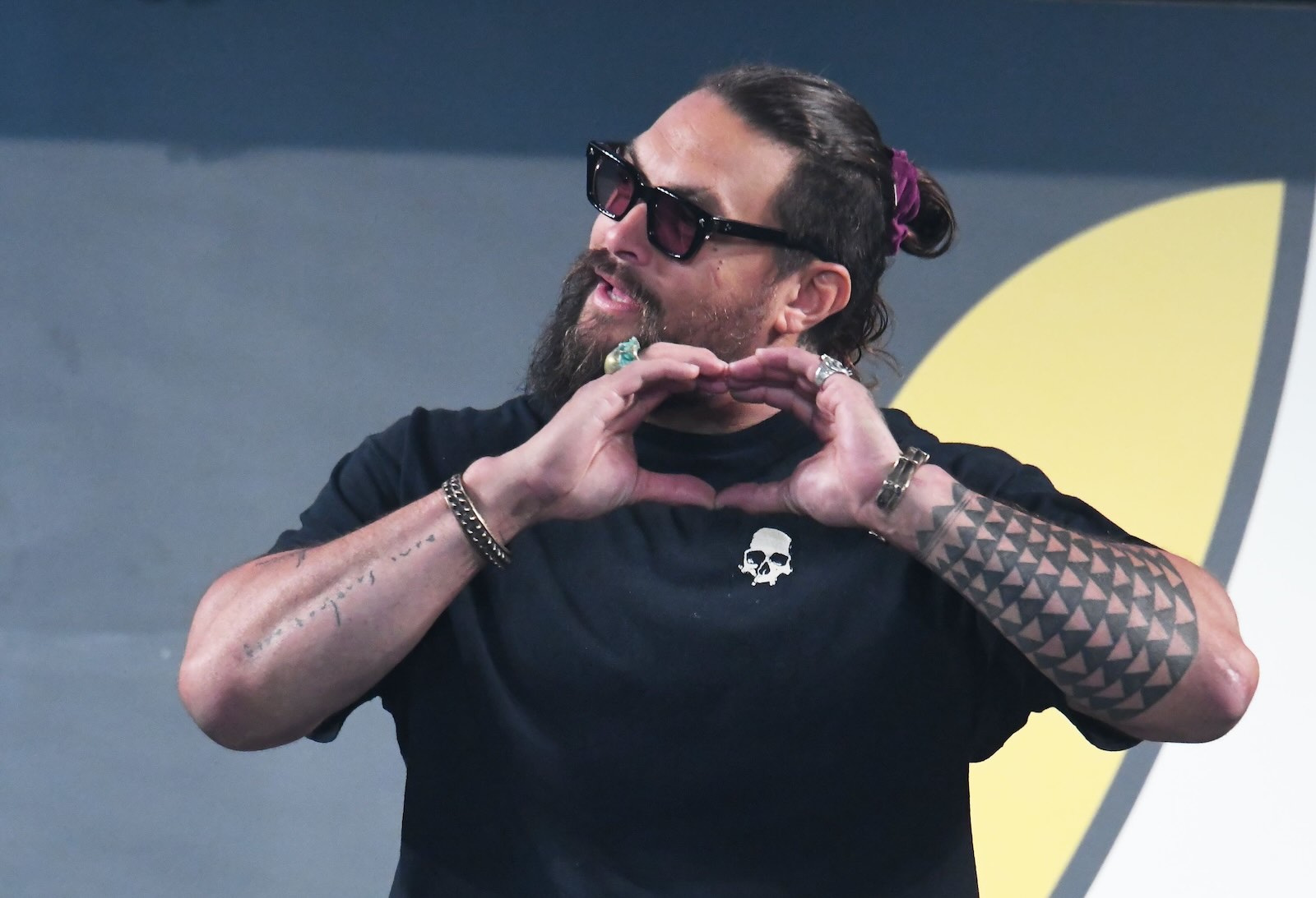 Actor Jason Momoa on stage at a convention