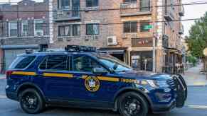 Blue New York State cruiser SUV driving through a city
