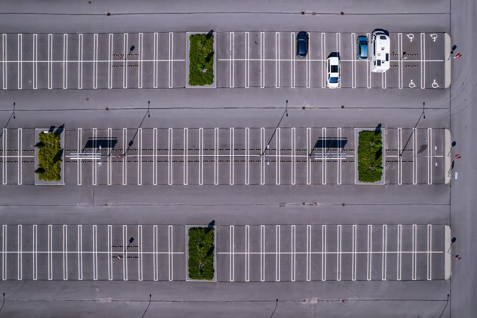 Overhead view of a parking lot with cars, RVs, and empty spaces