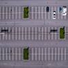 Overhead view of a parking lot with cars, RVs, and empty spaces