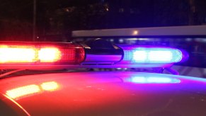 Red and light police lights on a cruiser's roof during a chase.